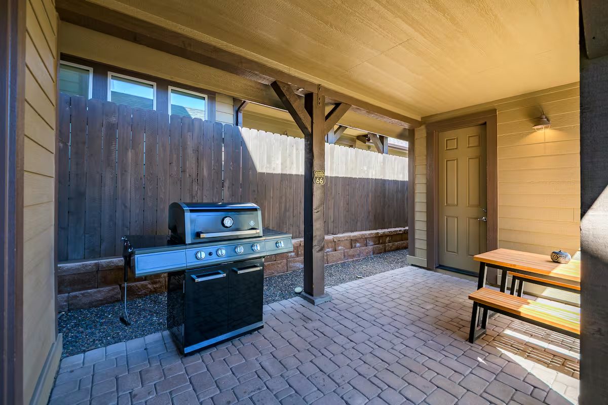 Covered patio with grill and picnic table