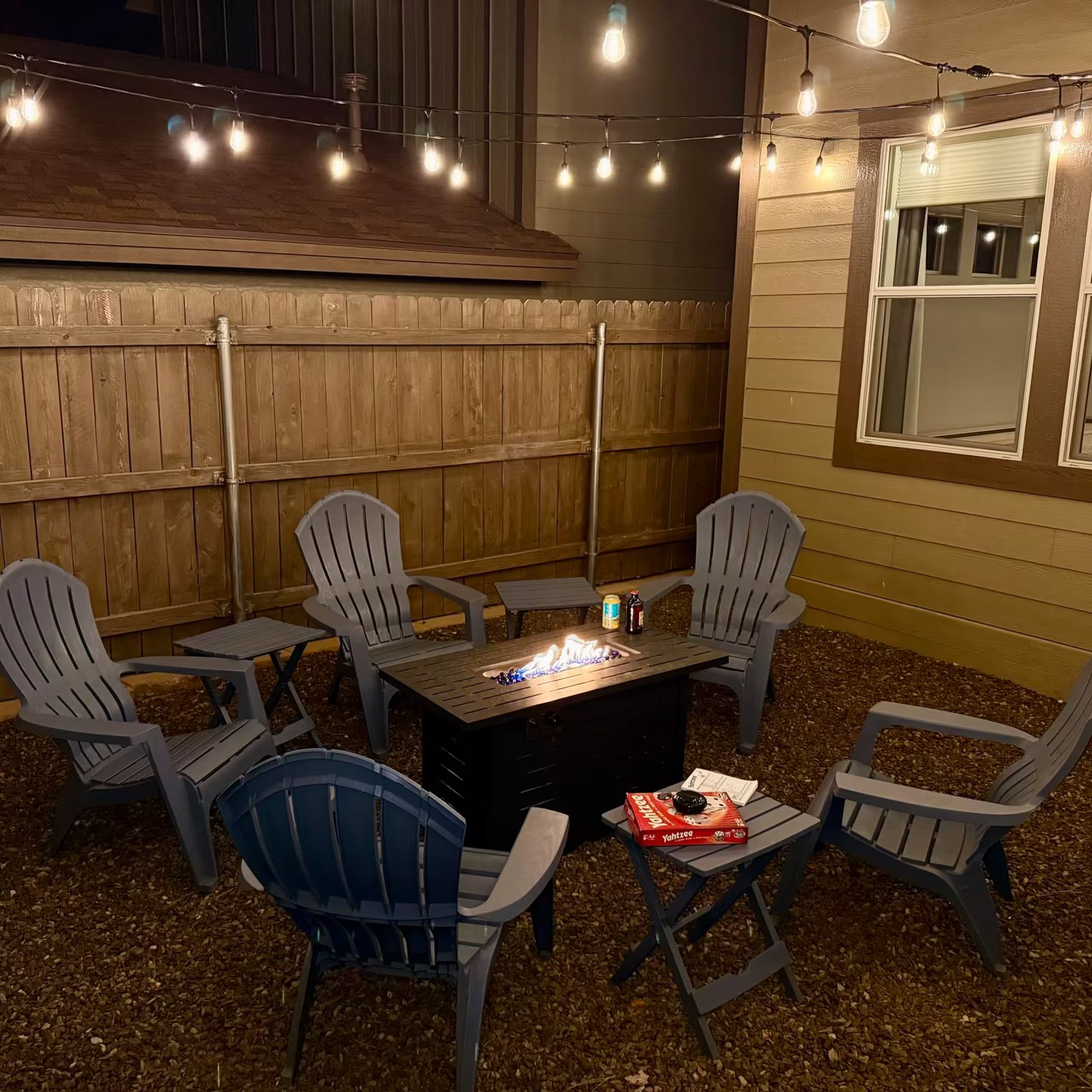 Fire pit at night under string lights